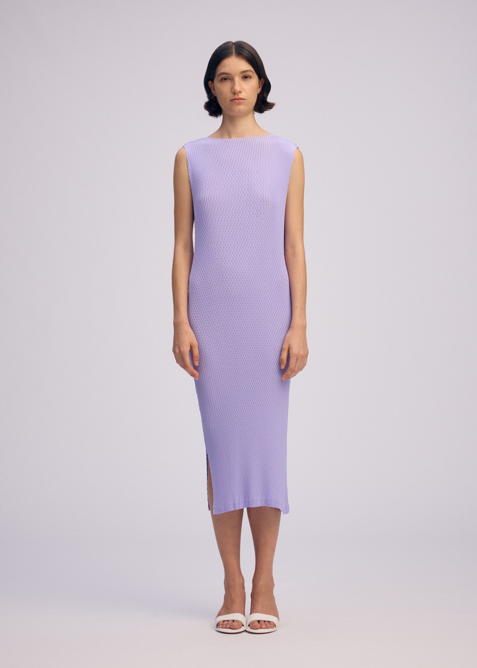 A model wears the ISSEY MIYAKE RHOMBUS PLEATS dress.