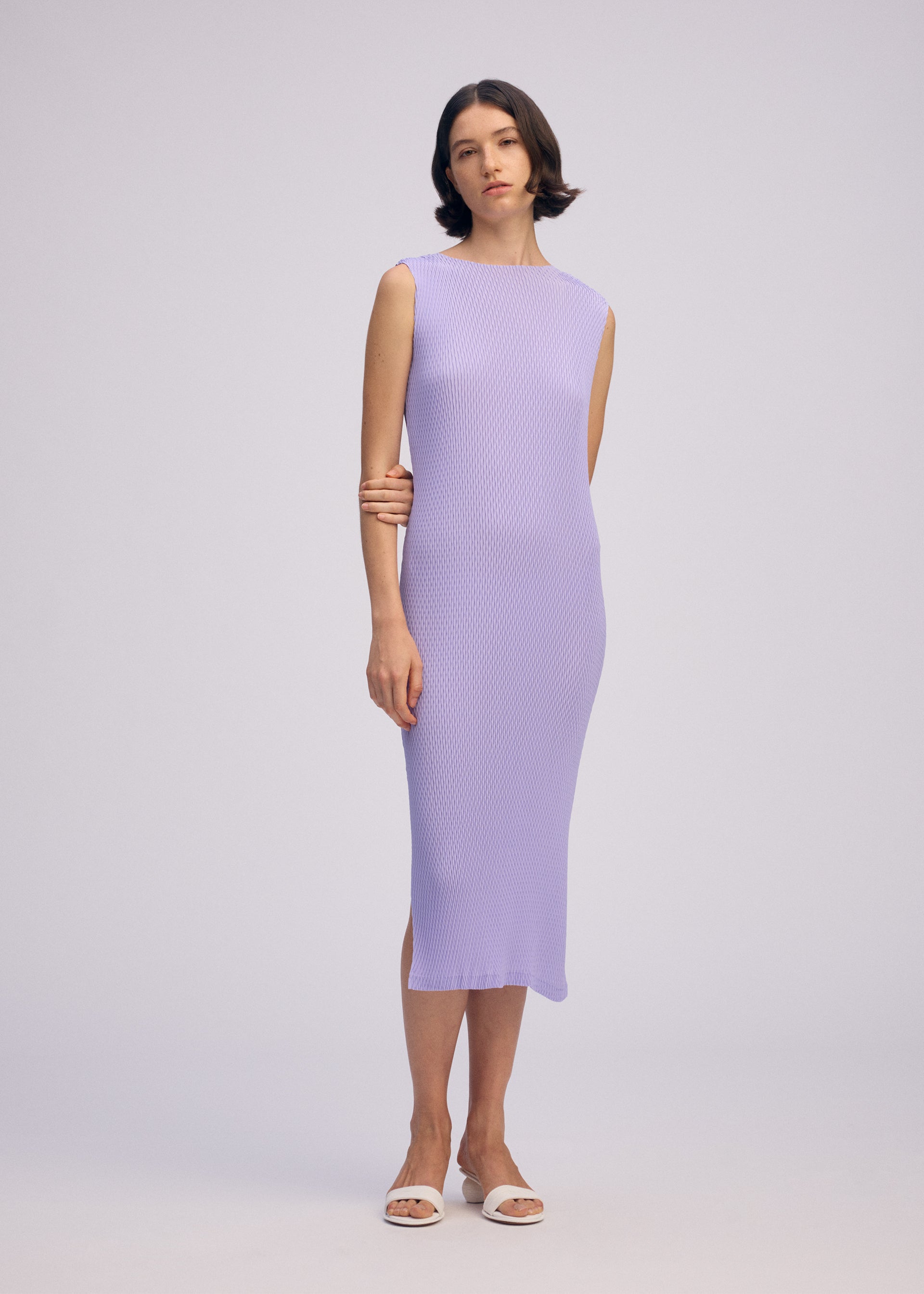 A model wears the ISSEY MIYAKE RHOMBUS PLEATS dress.