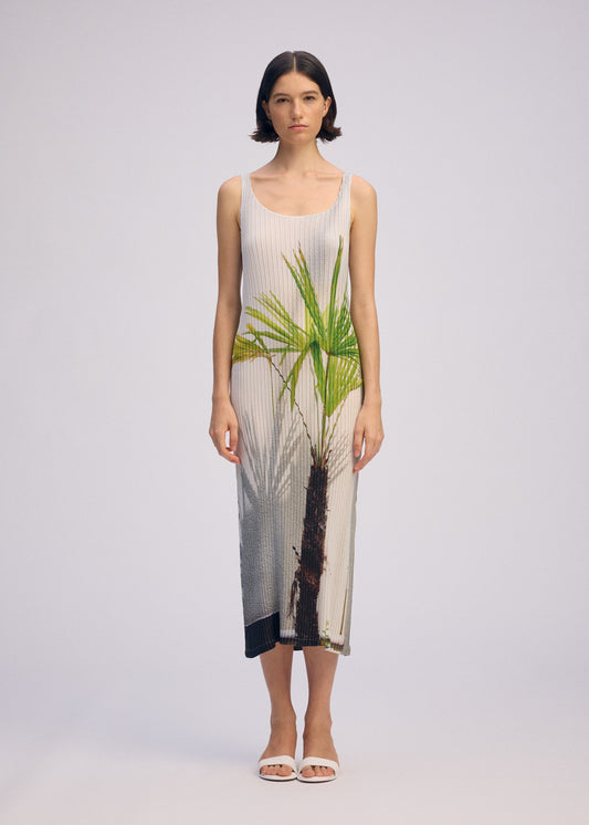 A model wears the ISSEY MIYAKE URBAN JUNGLE PLEATS dress.