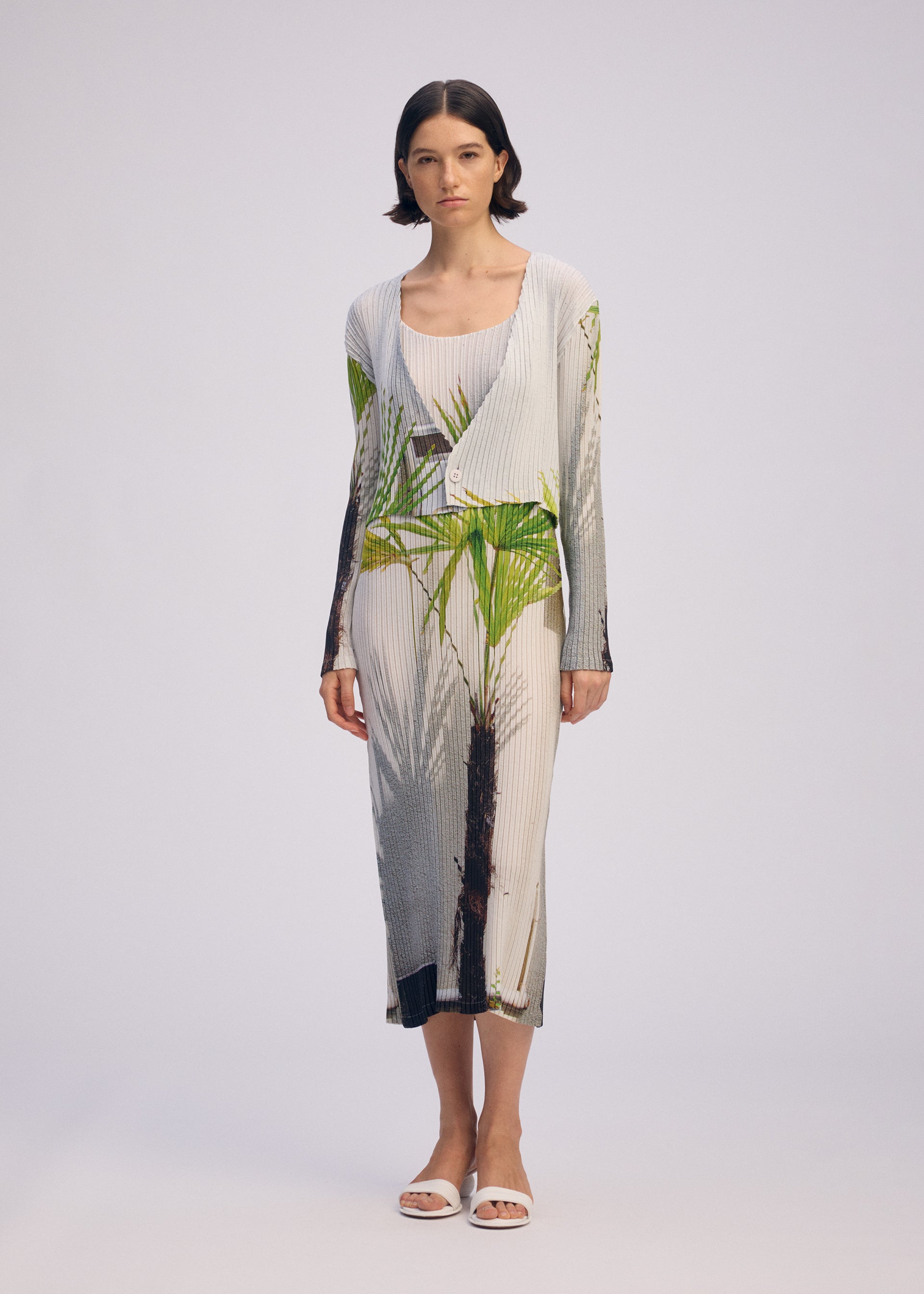 A model wears the ISSEY MIYAKE URBAN JUNGLE PLEATS dress.