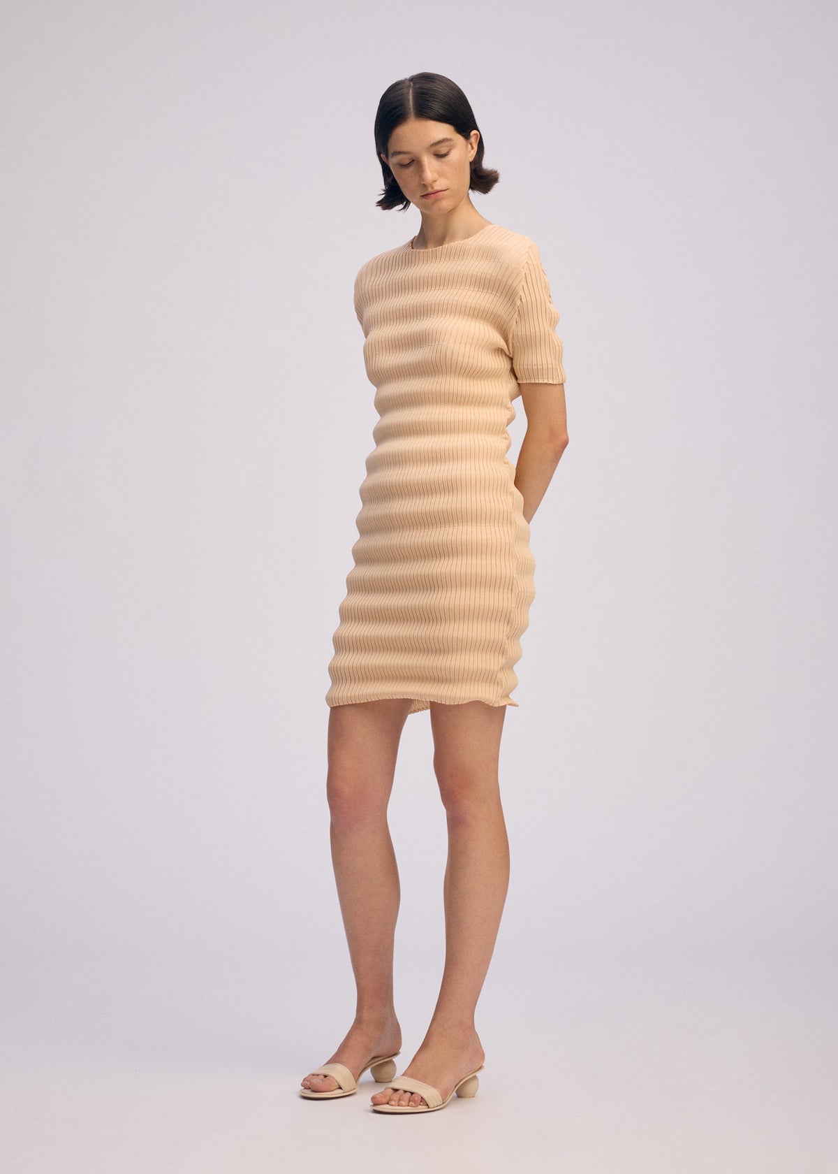 A model wears the ISSEY MIYAKE SPRING PLEATS spring-pleats-dress-starling-blue.