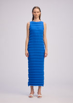 A model wears the ISSEY MIYAKE SPRING PLEATS spring-pleats-dress-black-1.