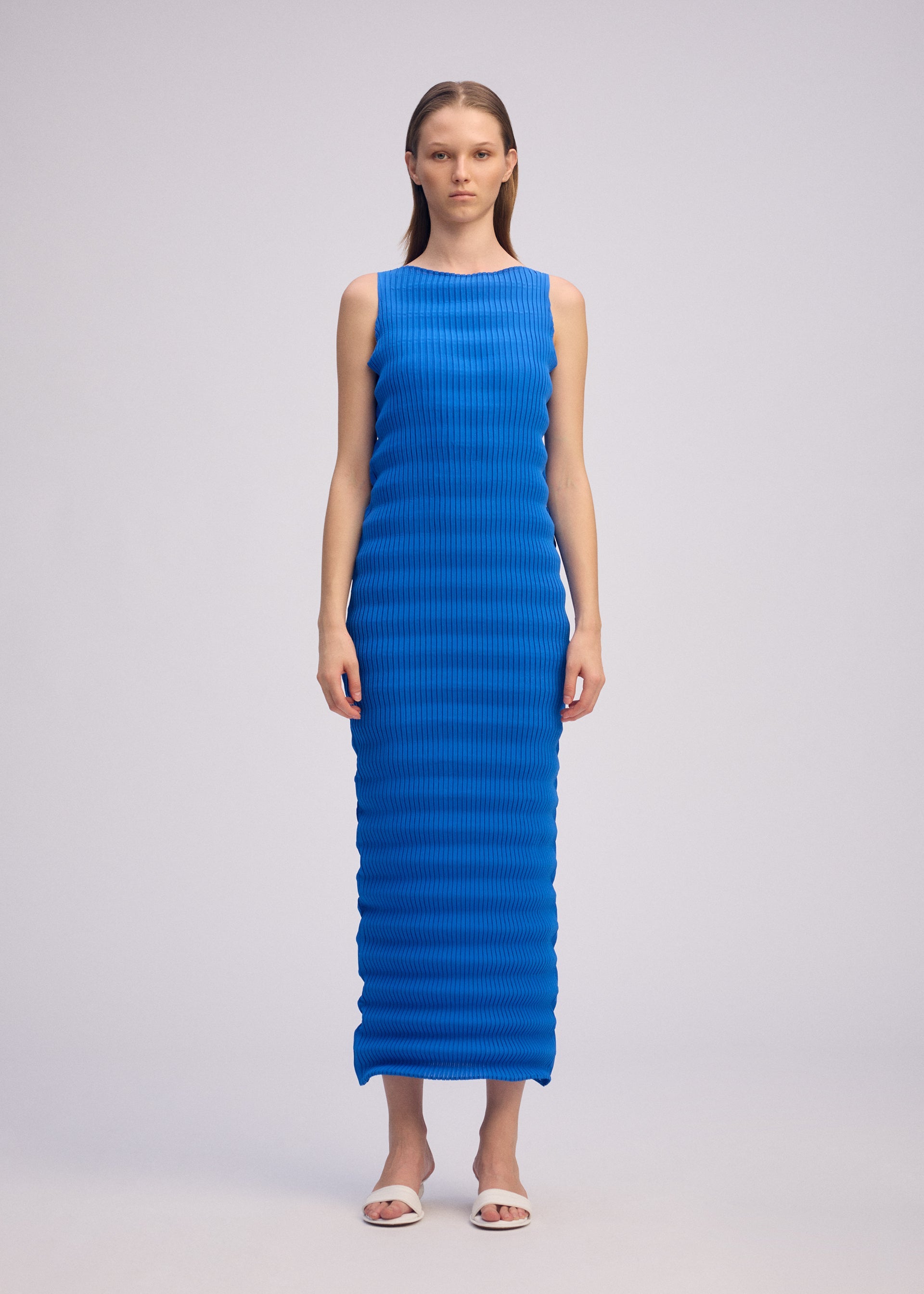 A model wears the ISSEY MIYAKE SPRING PLEATS spring-pleats-dress-starling-blue-1.