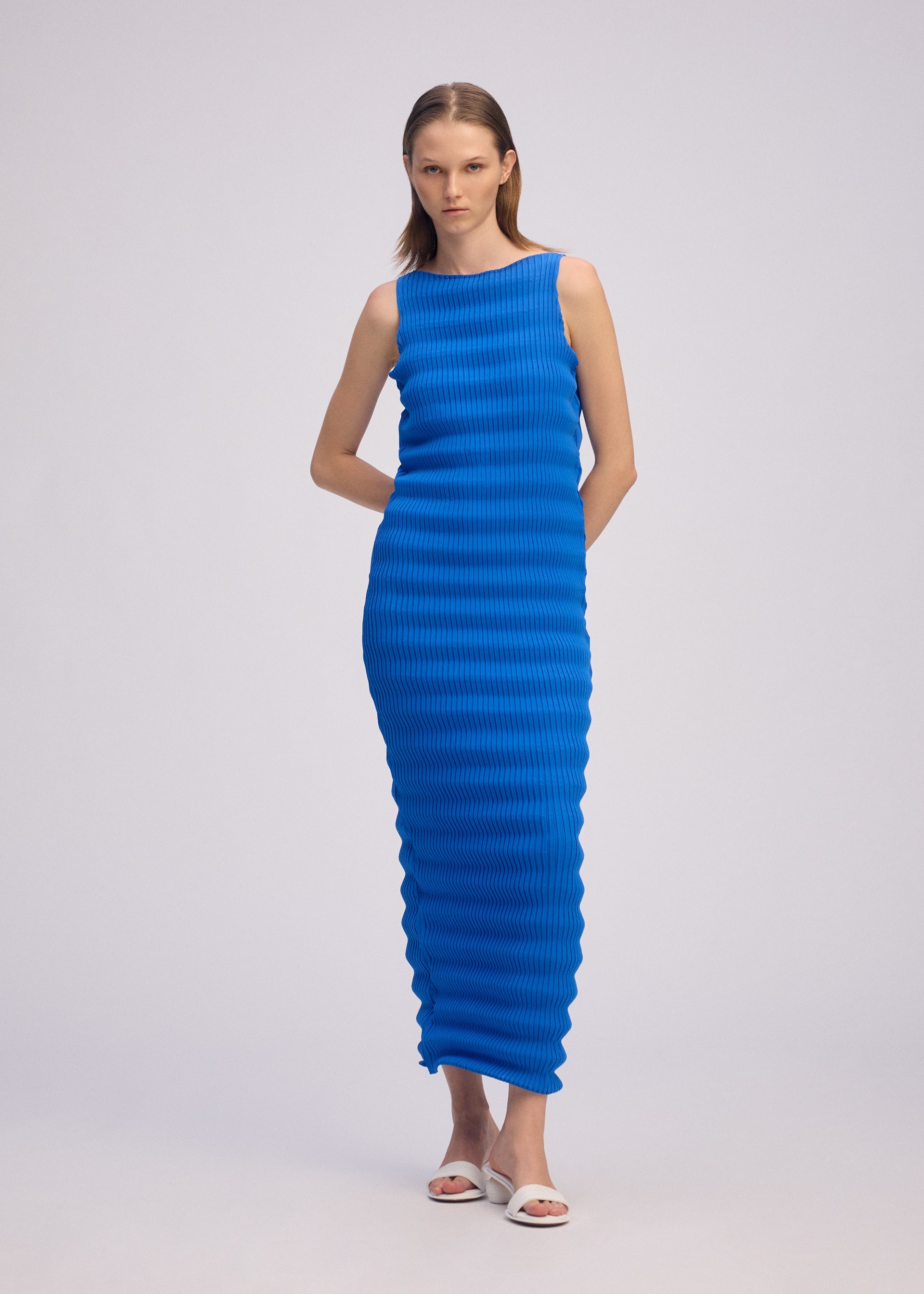 A model wears the ISSEY MIYAKE SPRING PLEATS spring-pleats-dress-starling-blue-1.