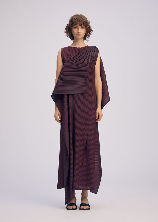 A model wears the ISSEY MIYAKE PLEATED ON PLEATS dress.