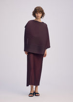 A model wears the ISSEY MIYAKE PLEATED ON PLEATS dress.