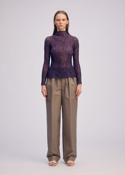 A model wears the ISSEY MIYAKE CHIFFON TWIST 2 shirt.
