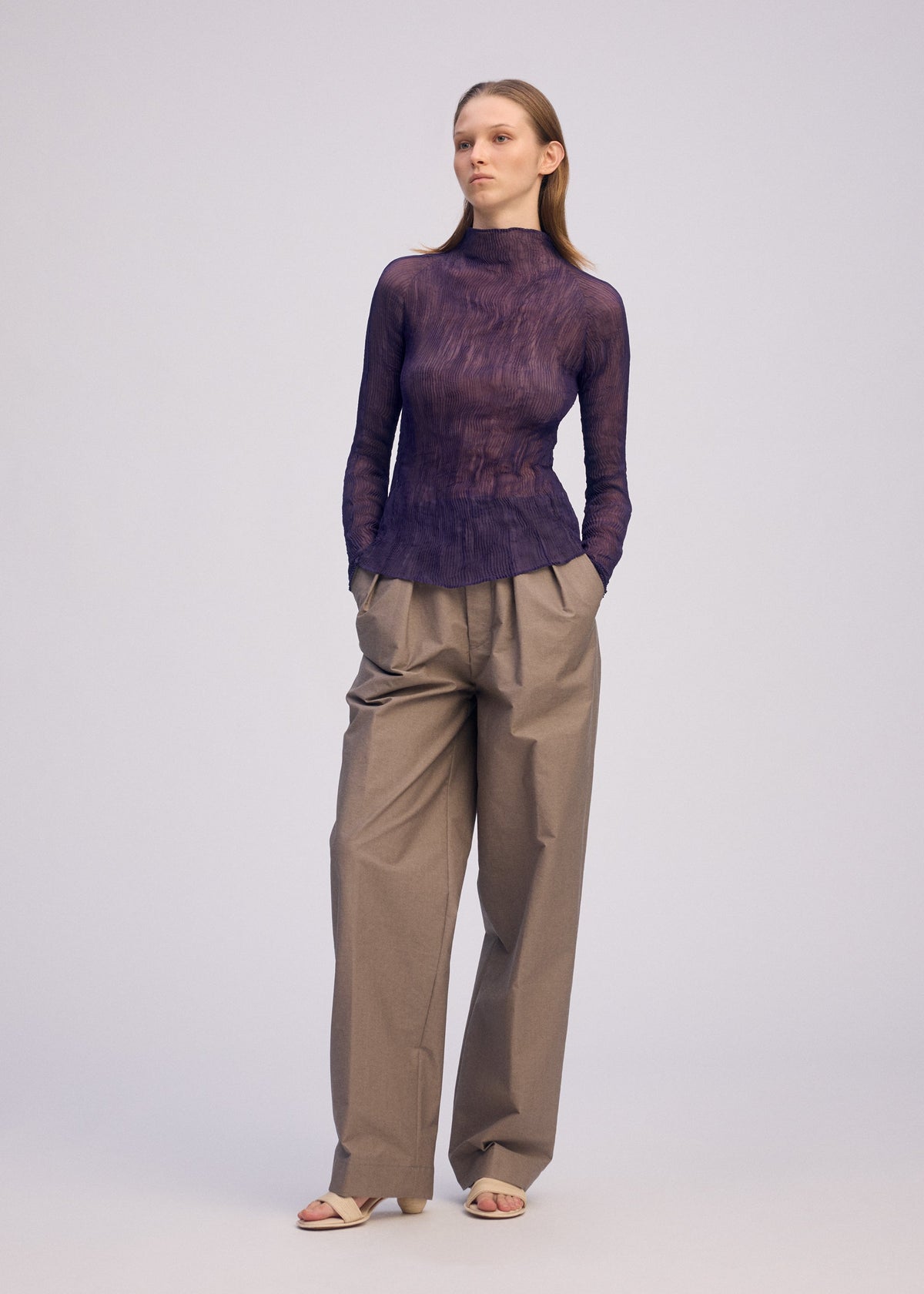 A model wears the ISSEY MIYAKE CHIFFON TWIST 2 shirt.
