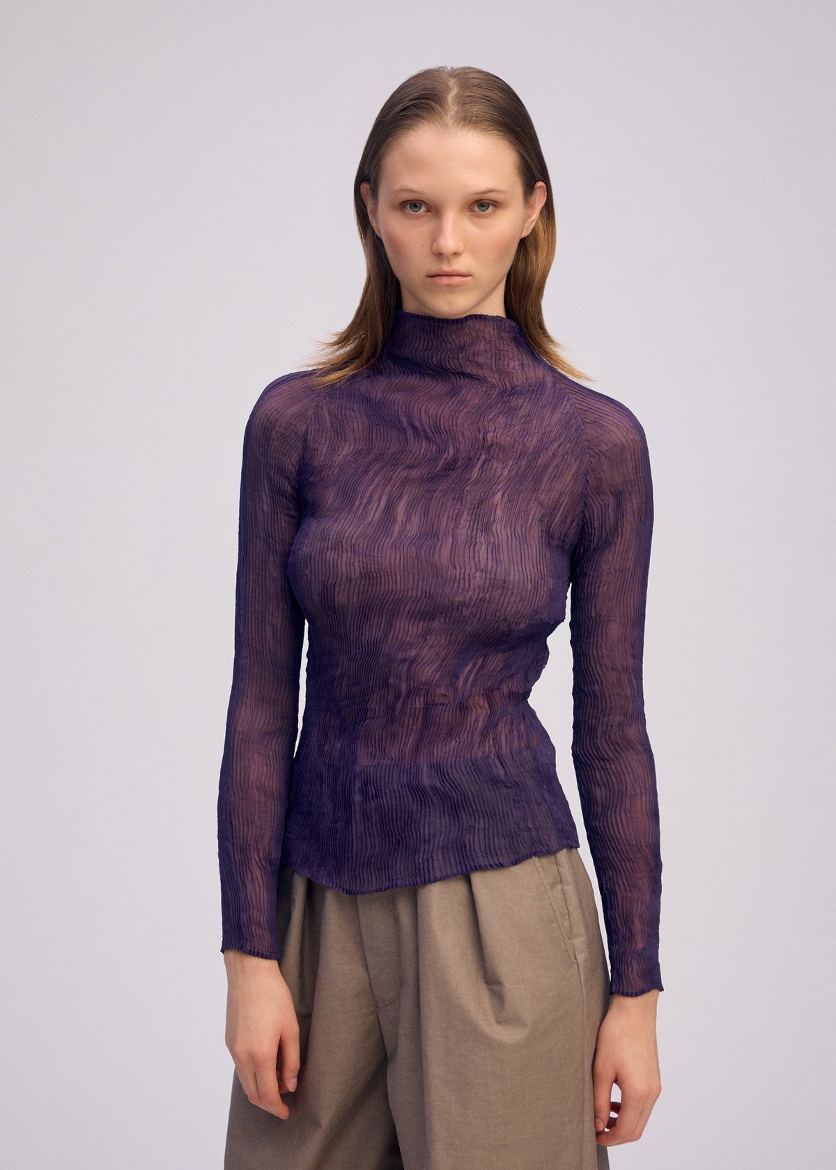 A model wears the ISSEY MIYAKE CHIFFON TWIST 2 shirt.