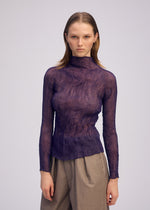 A model wears the ISSEY MIYAKE CHIFFON TWIST 2 shirt.