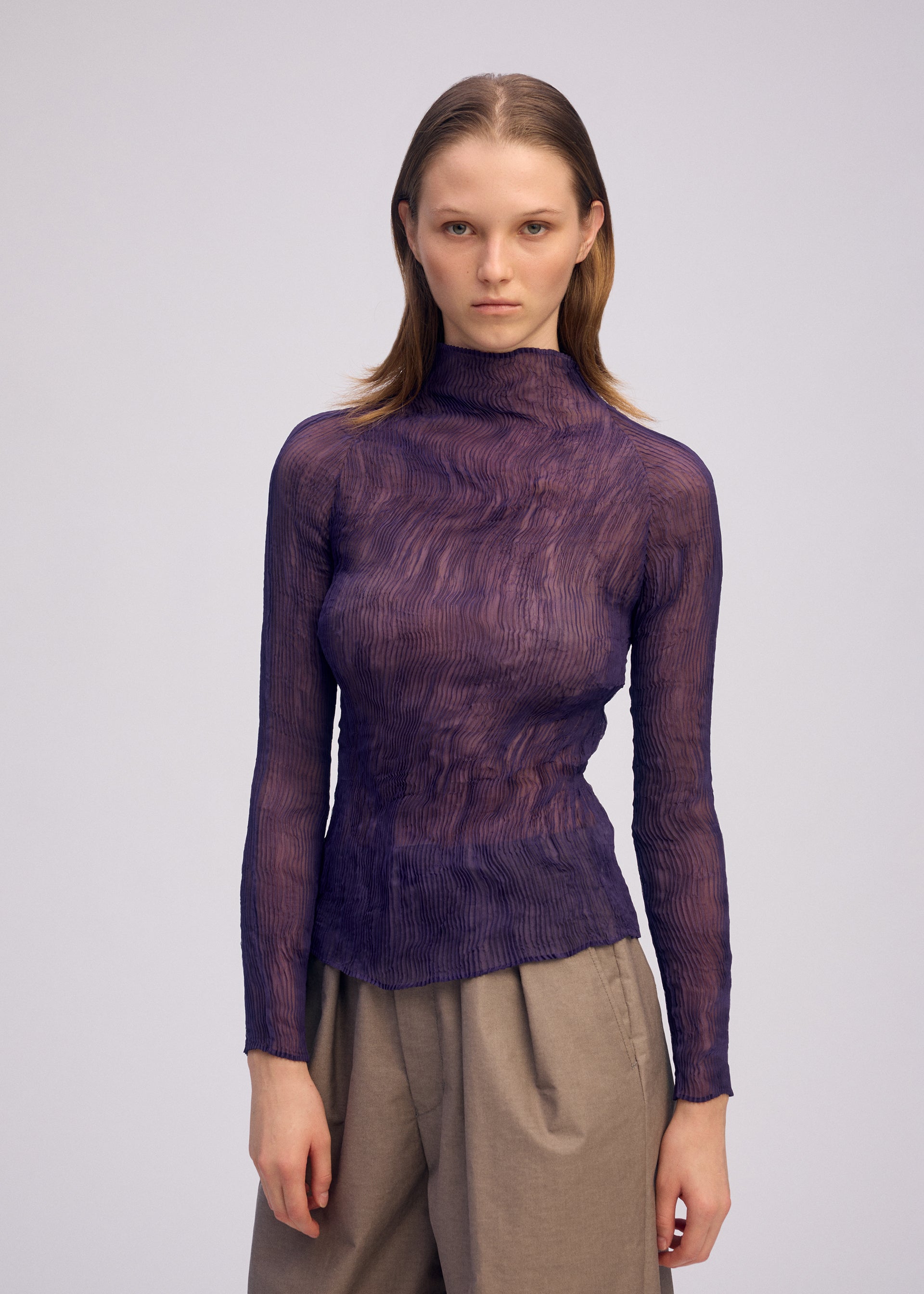 A model wears the ISSEY MIYAKE CHIFFON TWIST 2 shirt.