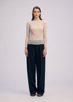 A model wears the ISSEY MIYAKE CHIFFON TWIST 3 top.