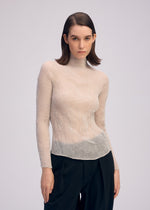 A model wears the ISSEY MIYAKE CHIFFON TWIST 3 top.