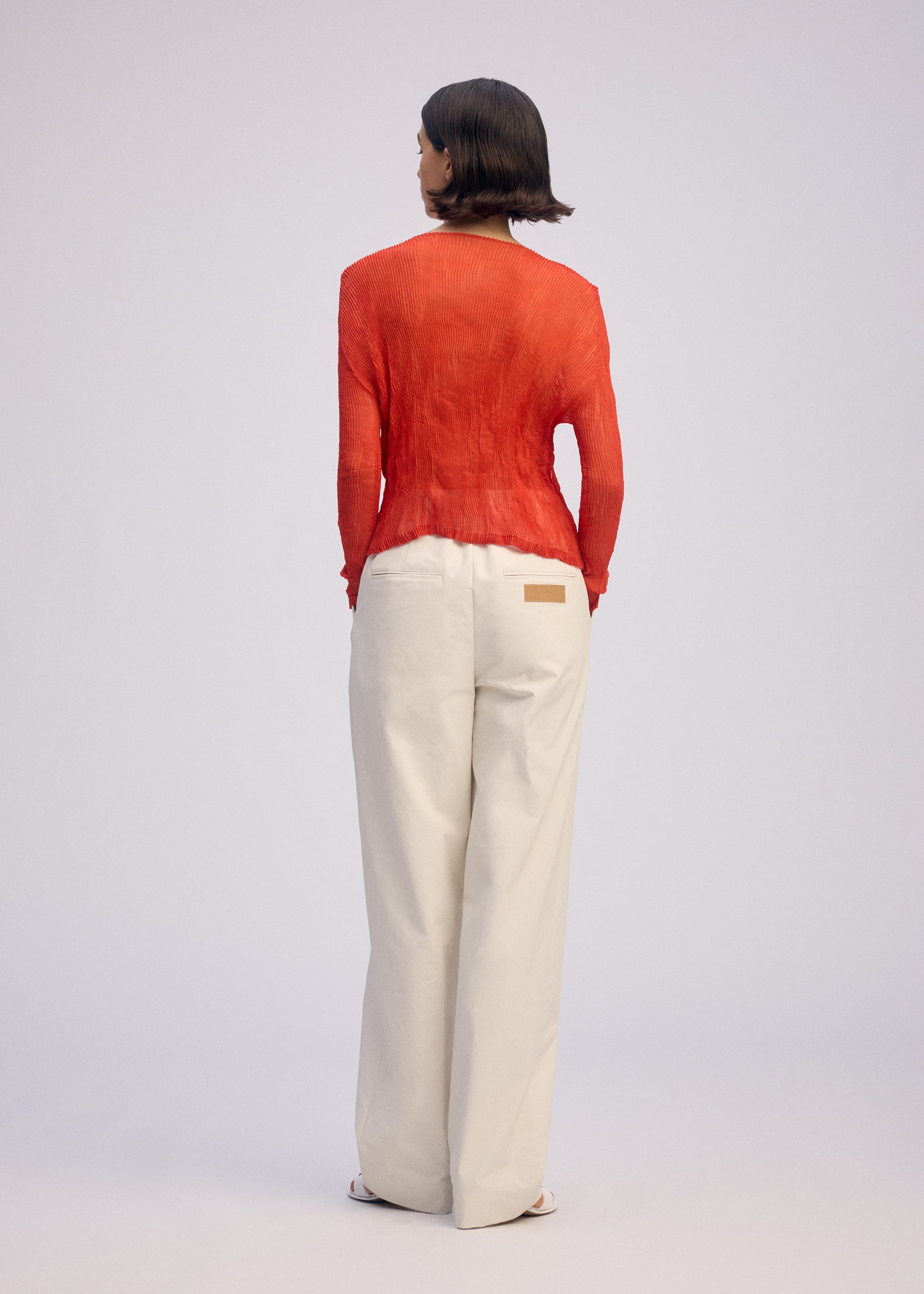 A model wears the ISSEY MIYAKE CHIFFON TWIST 2 shirt.