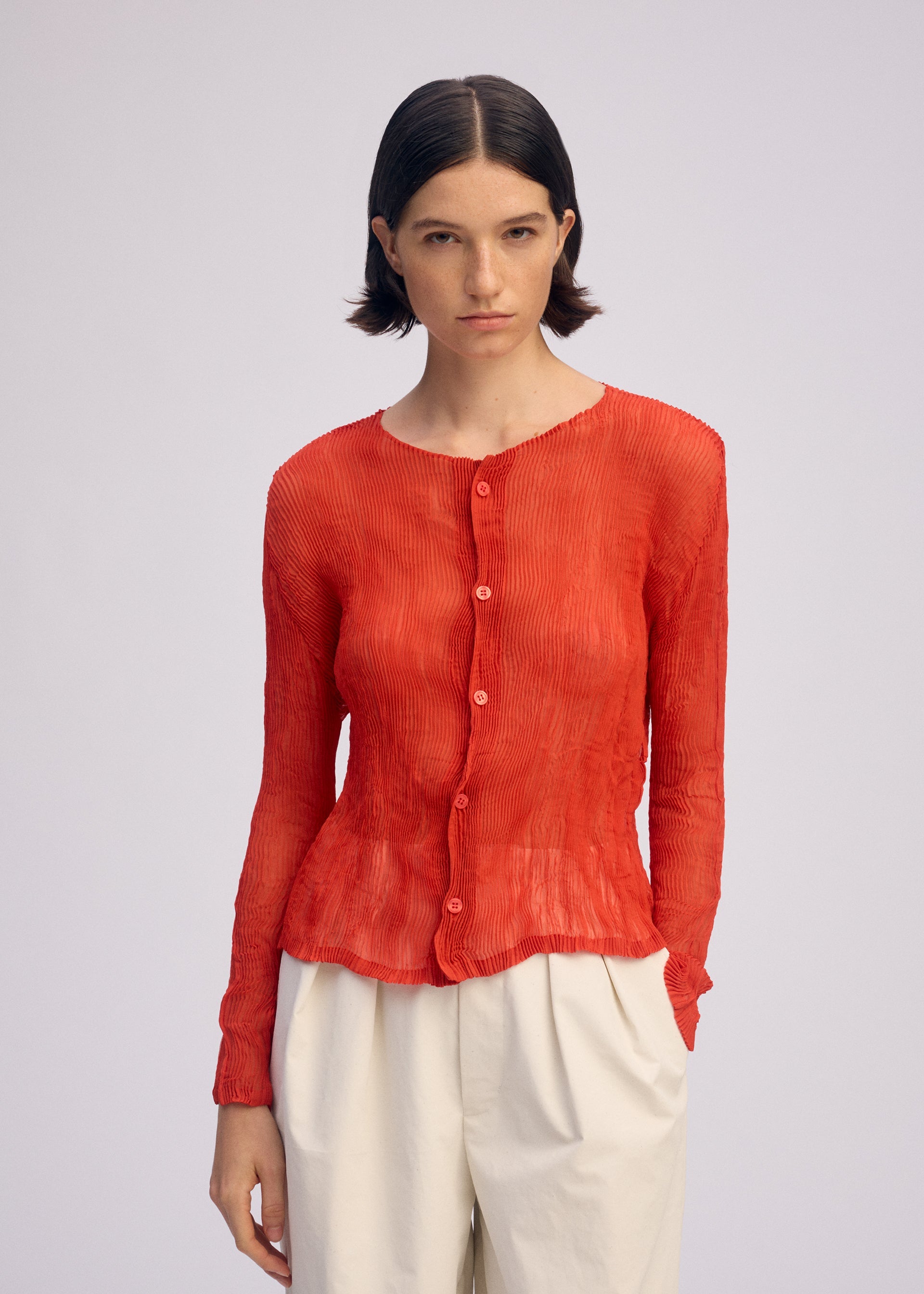 A model wears the ISSEY MIYAKE CHIFFON TWIST 2 shirt.