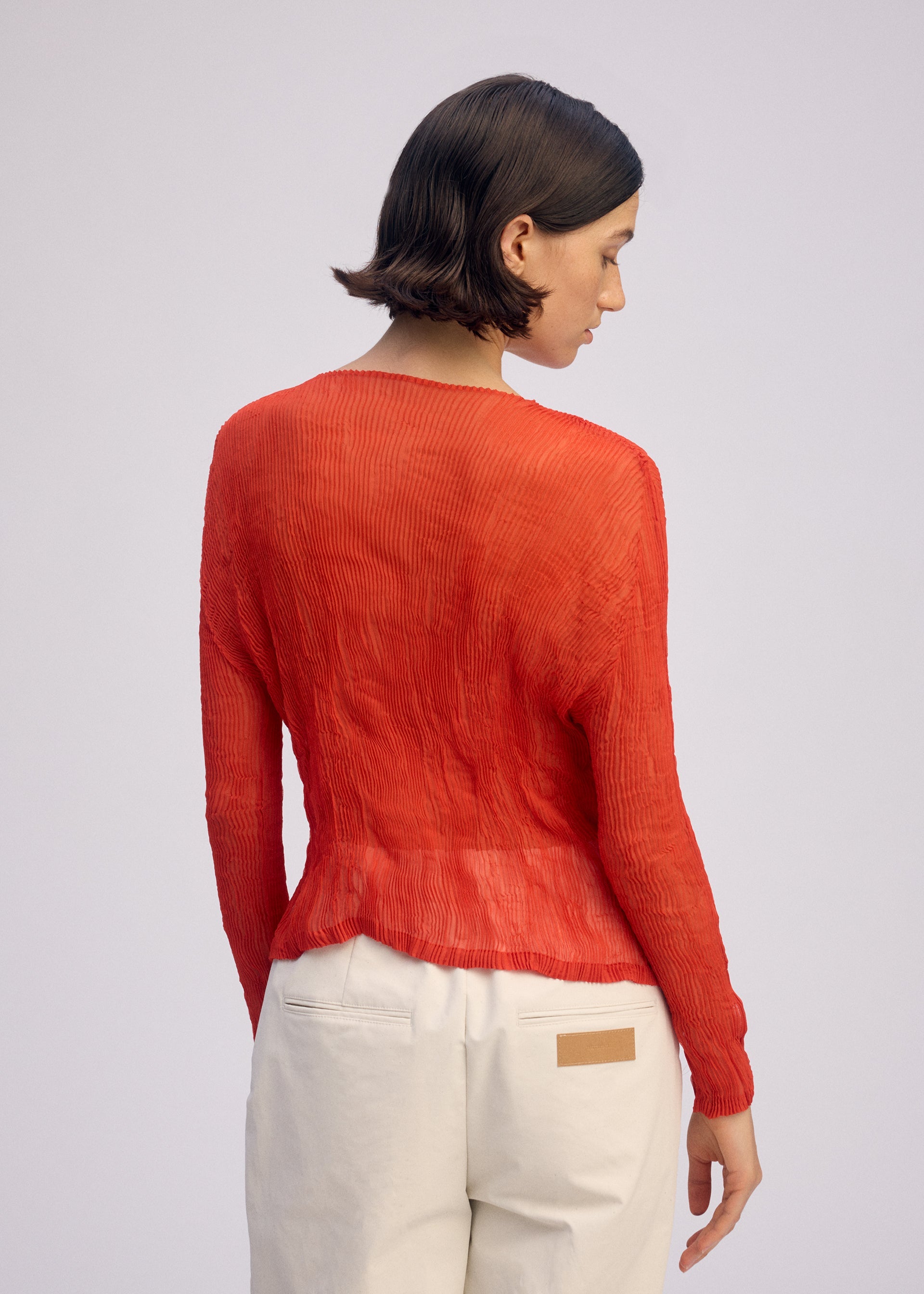 A model wears the ISSEY MIYAKE CHIFFON TWIST 2 shirt.