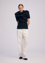 A model wears the ISSEY MIYAKE GENERIC WEAR shirt.
