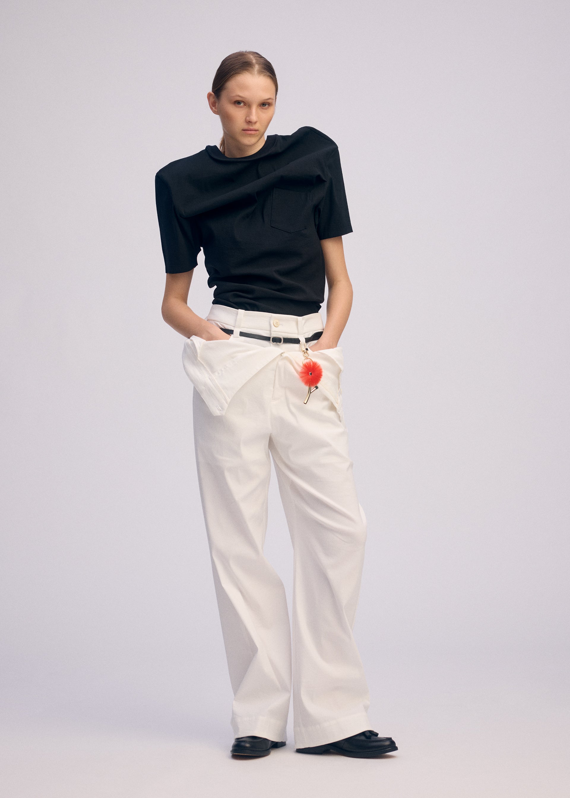 A model wears the ISSEY MIYAKE GENERIC WEAR shirt.