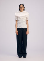 A model wears the ISSEY MIYAKE GENERIC WEAR shirt.
