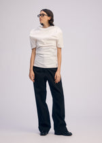 A model wears the ISSEY MIYAKE GENERIC WEAR shirt.