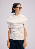 A model wears the ISSEY MIYAKE GENERIC WEAR shirt.