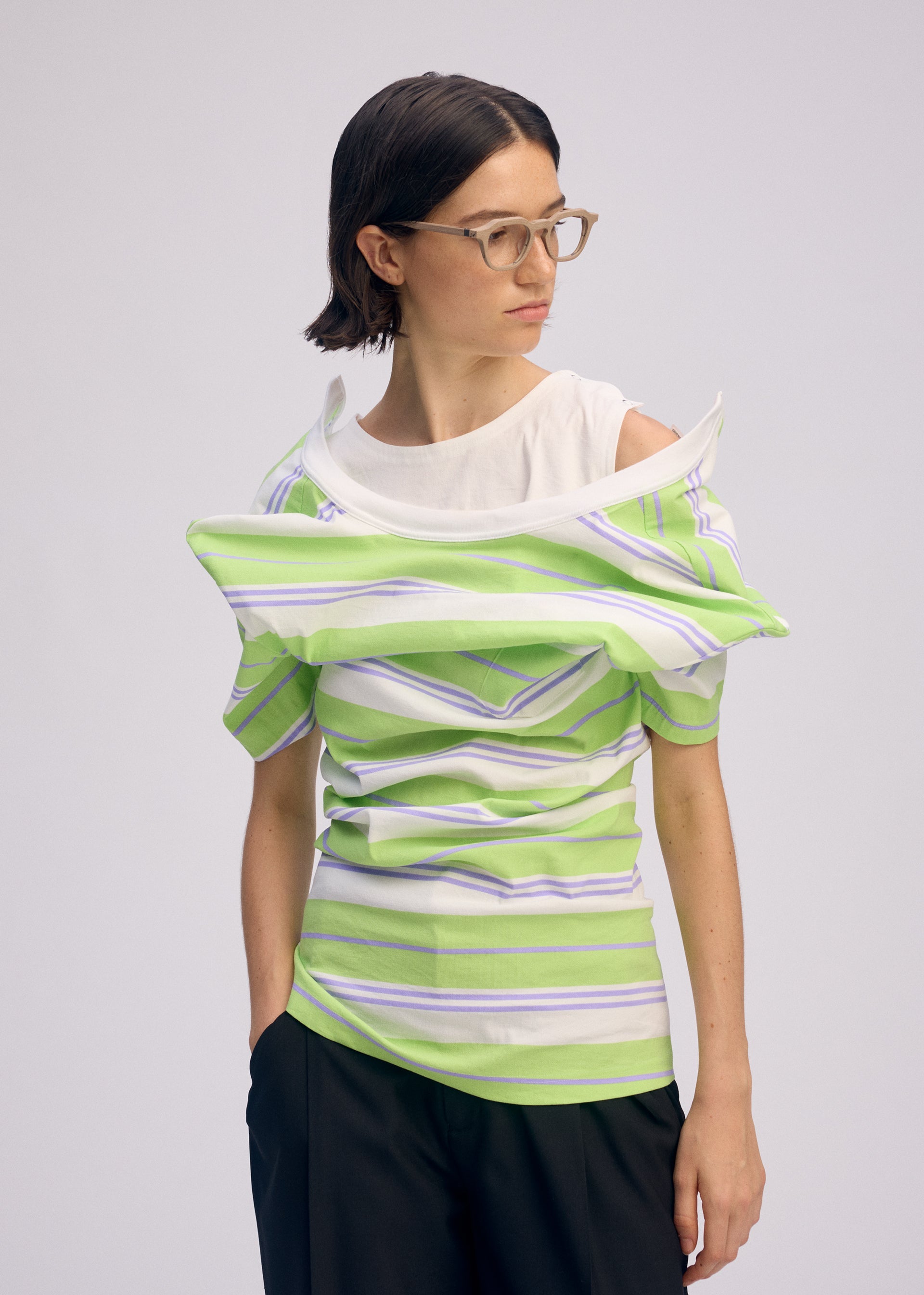 A model wears the ISSEY MIYAKE GENERIC WEAR STRIPES shirt.