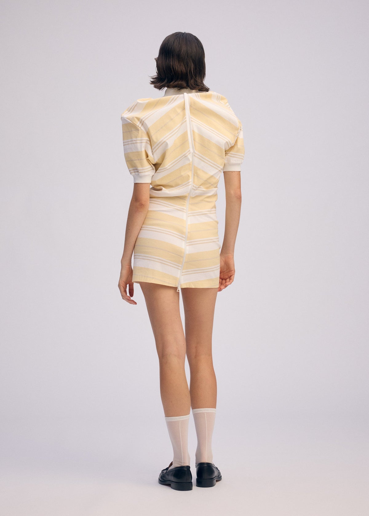 A model wears the ISSEY MIYAKE GENERIC WEAR STRIPES shirt.