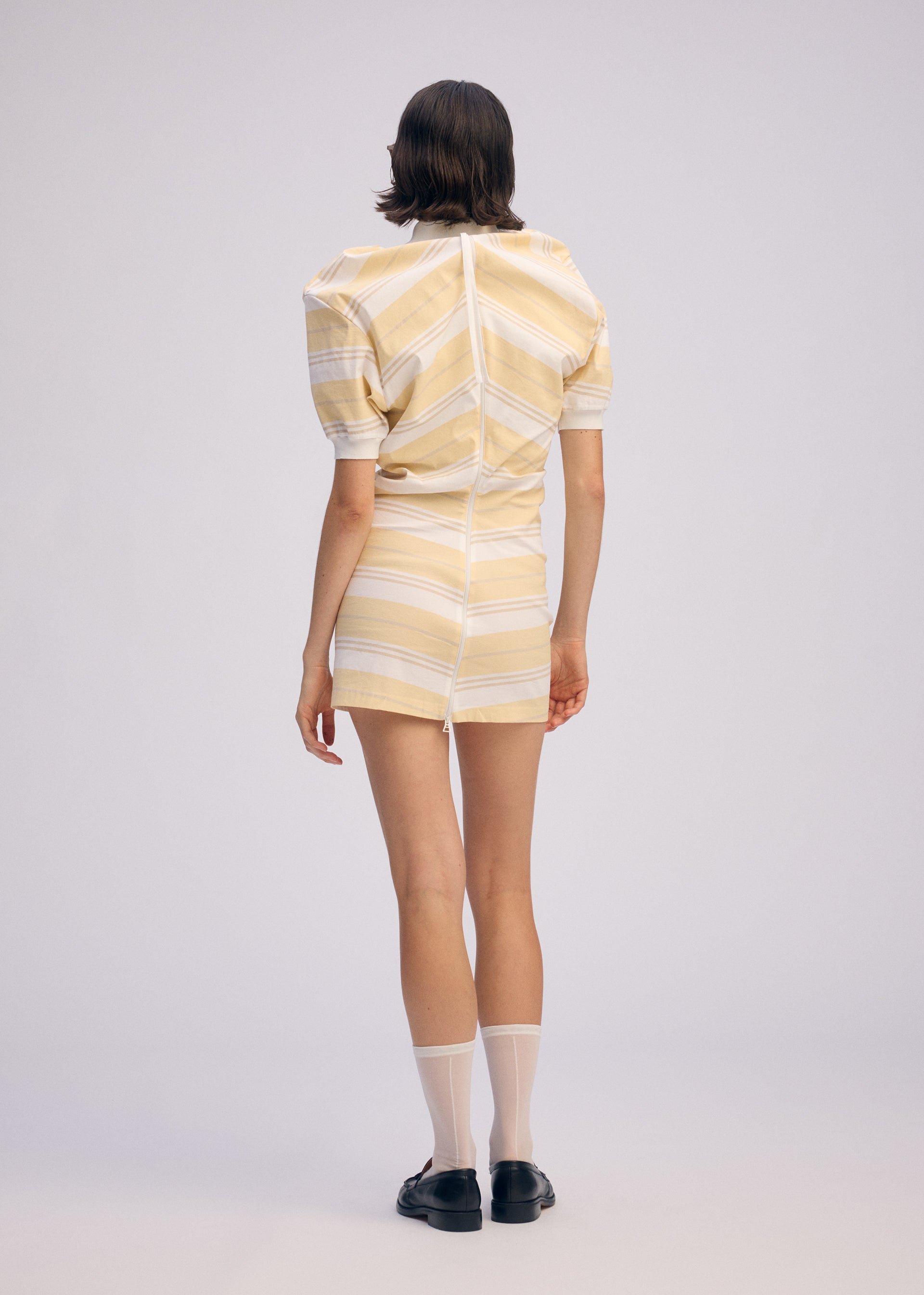 A model wears the ISSEY MIYAKE GENERIC WEAR STRIPES shirt.