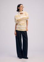 A model wears the ISSEY MIYAKE GENERIC WEAR STRIPES shirt.