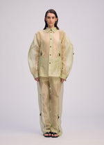 A model wears the ISSEY MIYAKE DRAW TO FORM shirt.