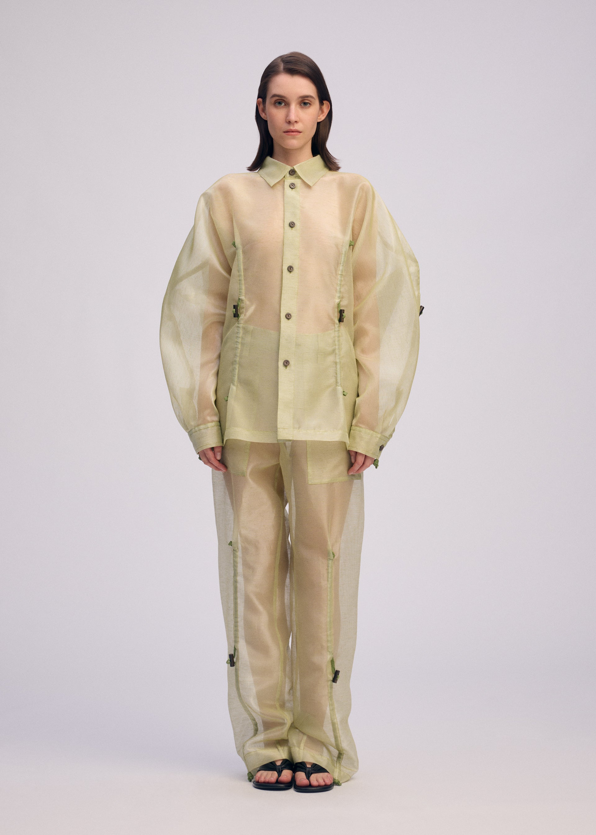 A model wears the ISSEY MIYAKE DRAW TO FORM shirt.