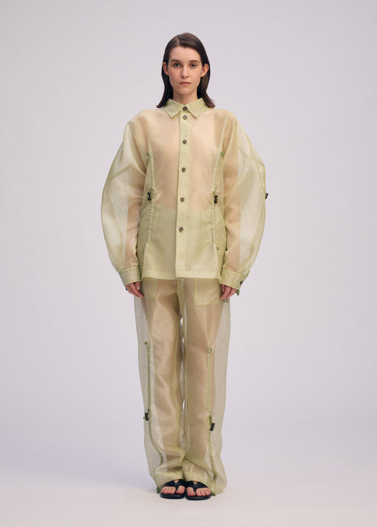 A model wears the ISSEY MIYAKE DRAW TO FORM shirt.