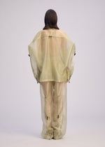 A model wears the ISSEY MIYAKE DRAW TO FORM shirt.