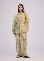 A model wears the ISSEY MIYAKE DRAW TO FORM shirt.