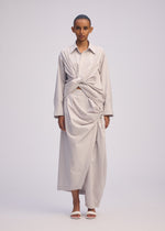 A model wears the ISSEY MIYAKE TWISTED DRAPE shirt.