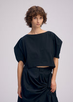 A model wears the ISSEY MIYAKE TWISTED DRAPE top.