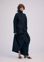 A model wears the ISSEY MIYAKE TWISTED DRAPE shirt.