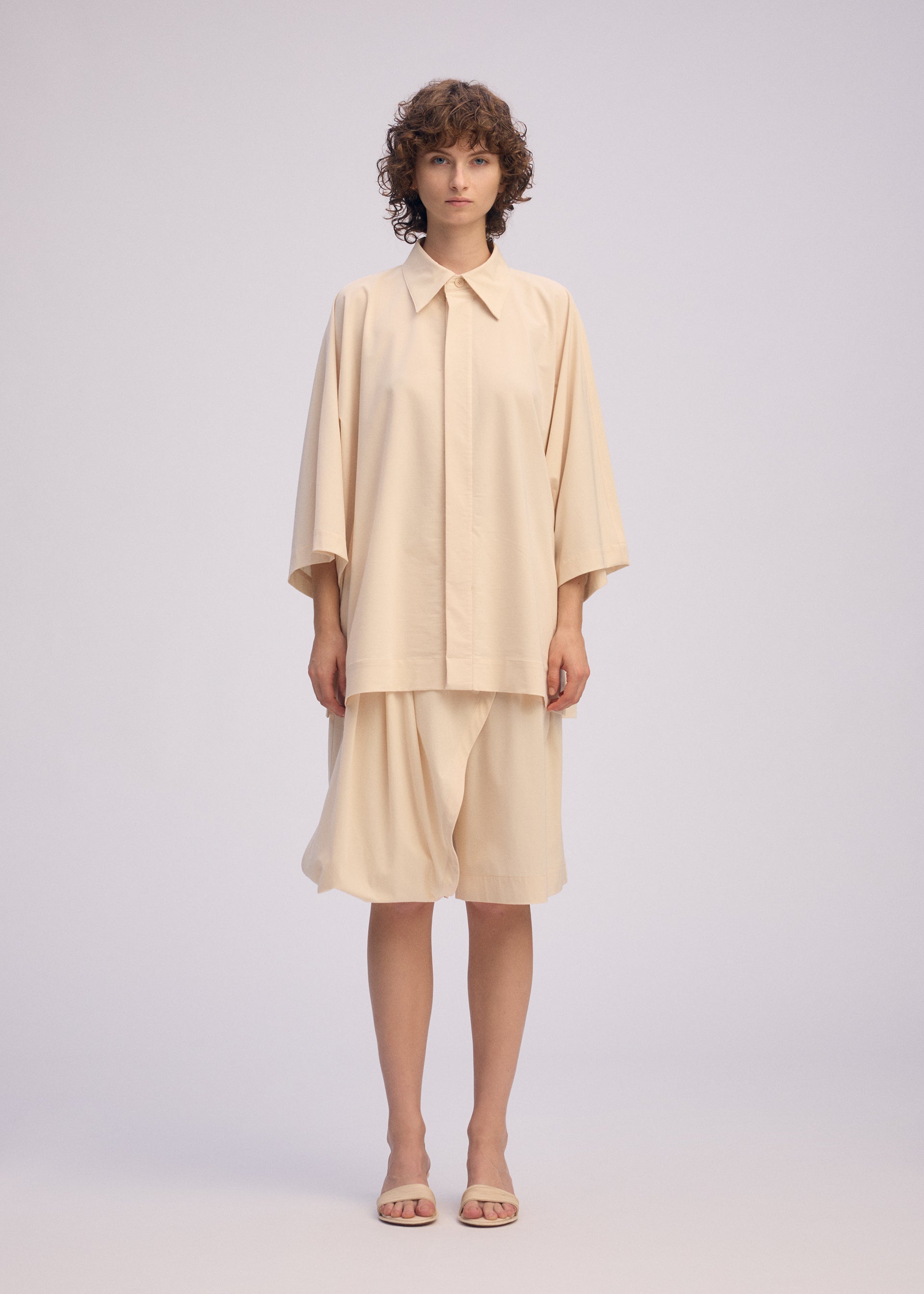 A model wears the ISSEY MIYAKE LOOPED shirt.