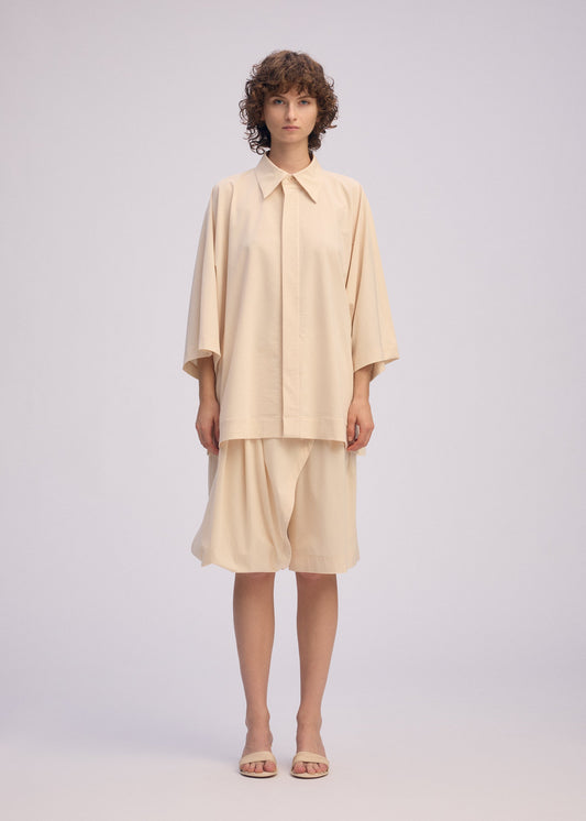 A model wears the ISSEY MIYAKE LOOPED shirt.