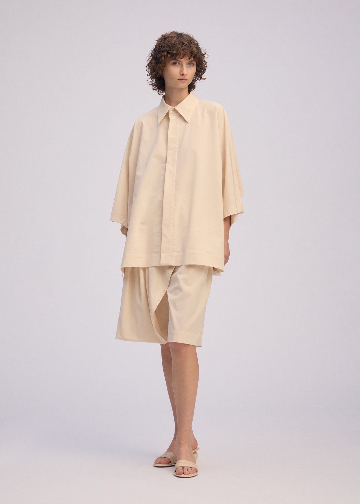 A model wears the ISSEY MIYAKE LOOPED shirt.