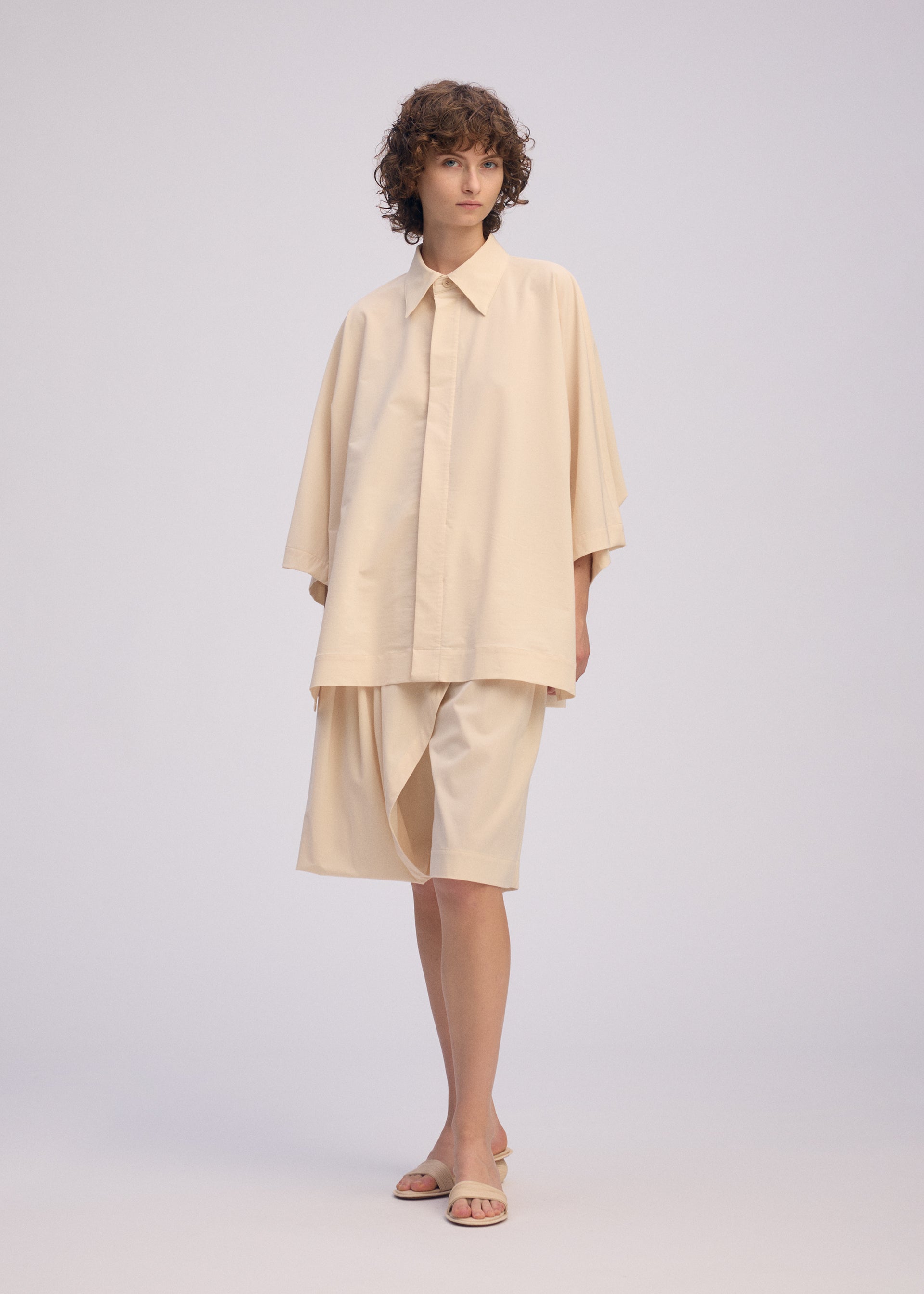 A model wears the ISSEY MIYAKE LOOPED shirt.