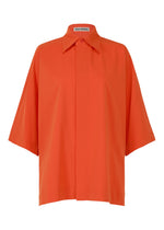 A product shot of the ISSEY MIYAKE LOOPED shirt in macaw red (28).