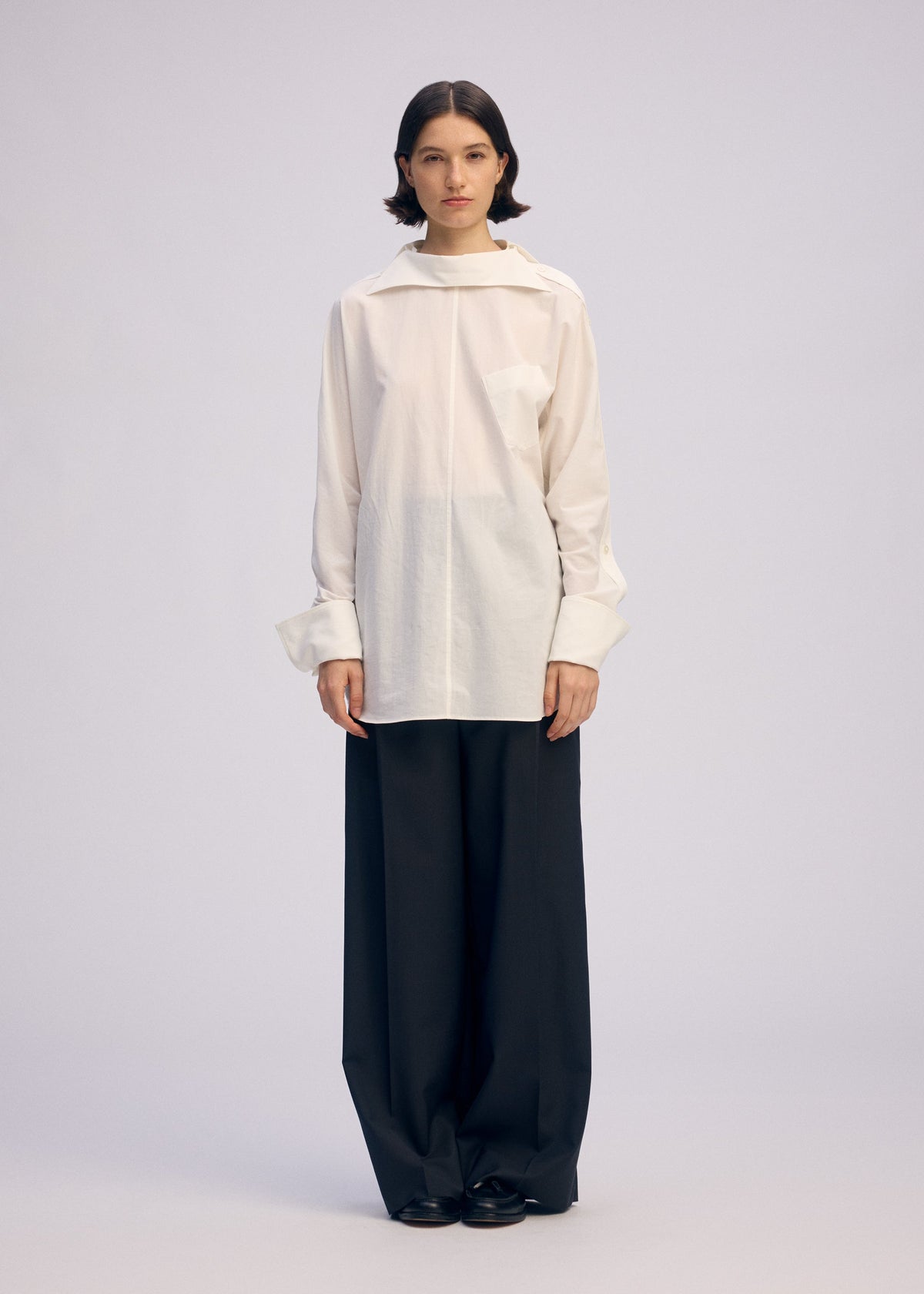 A model wears the ISSEY MIYAKE ODD SHIRT 2 shirt.