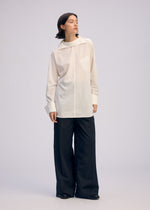 A model wears the ISSEY MIYAKE ODD SHIRT 2 shirt.