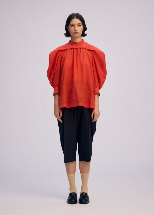 A model wears the ISSEY MIYAKE R SHIRT SHEER shirt.