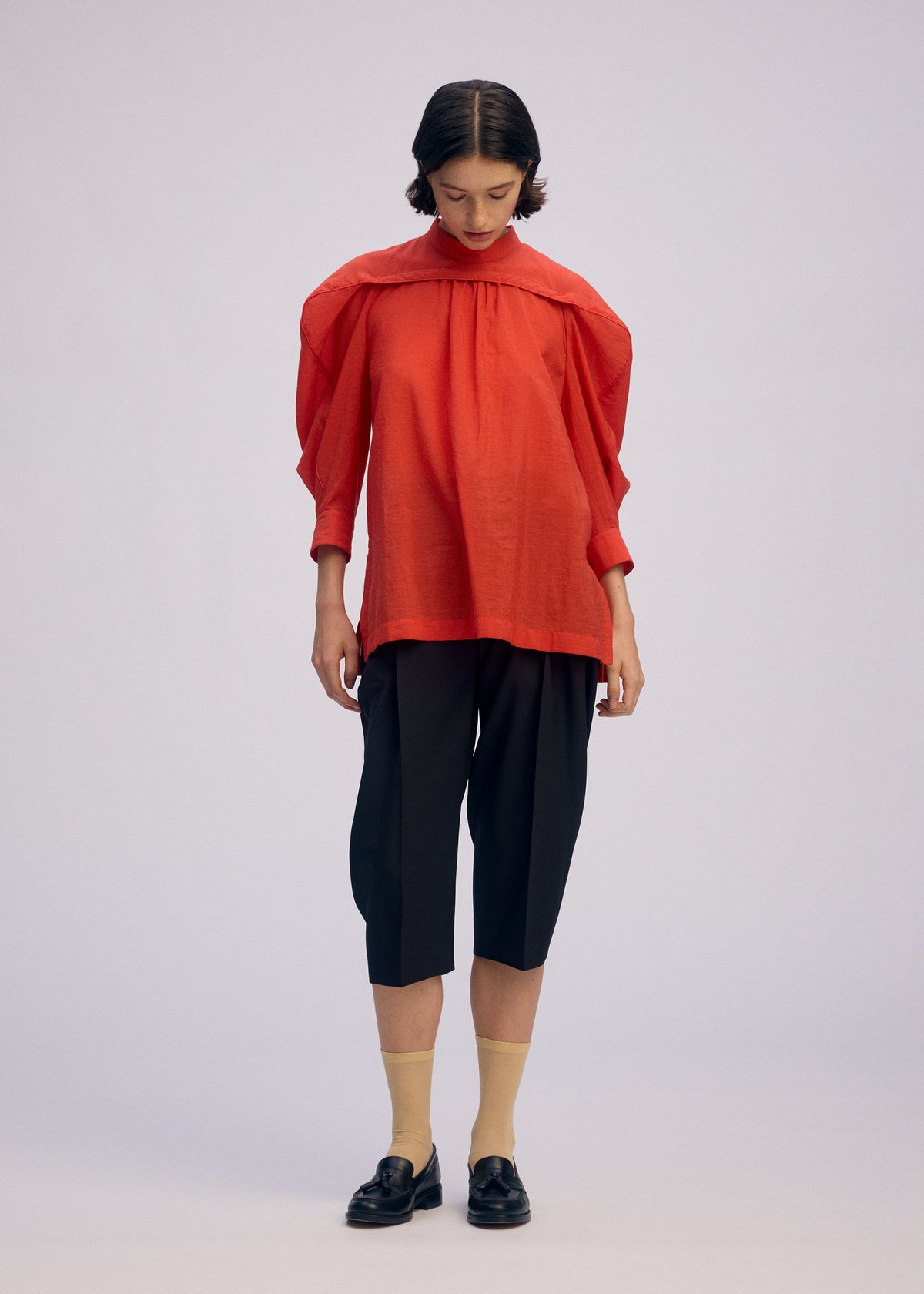 A model wears the ISSEY MIYAKE R SHIRT SHEER shirt.