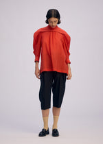 A model wears the ISSEY MIYAKE R SHIRT SHEER shirt.