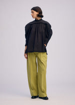 A model wears the ISSEY MIYAKE R SHIRT SHEER shirt.
