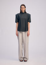 A model wears the ISSEY MIYAKE MUTE mute-shirt-light-grey.