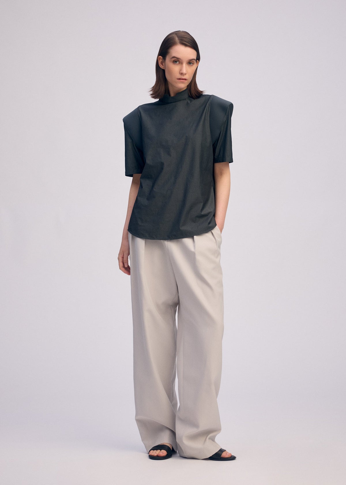 A model wears the ISSEY MIYAKE MUTE mute-shirt-light-grey.
